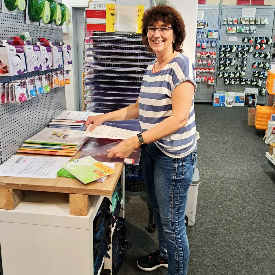 Mitarbeiterin fügt Schulbüchern Umschläge hinzu